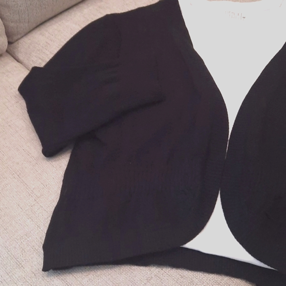Shrug. Open front lightweight sweater with waist detailing for shape.